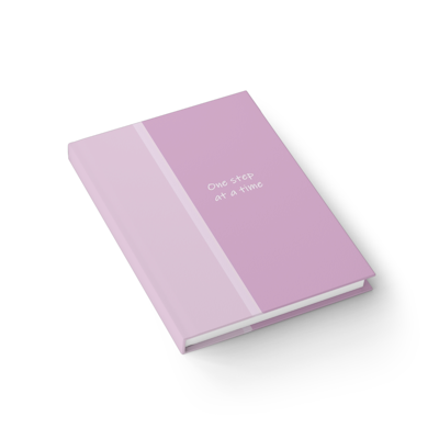purple hardcover journal notebook with the words, one step at a time