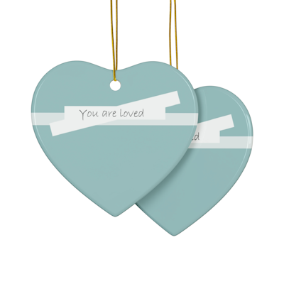 teal blue heart ceramic ornament with white bow detail and the words, you are loved
