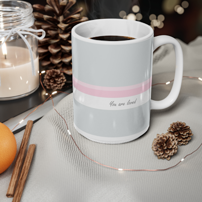 grey ceramic mug with pink and white horizontal stripes, and the words, you are loved.