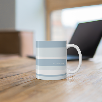 blue striped ceramic mug with the words, one step at a time