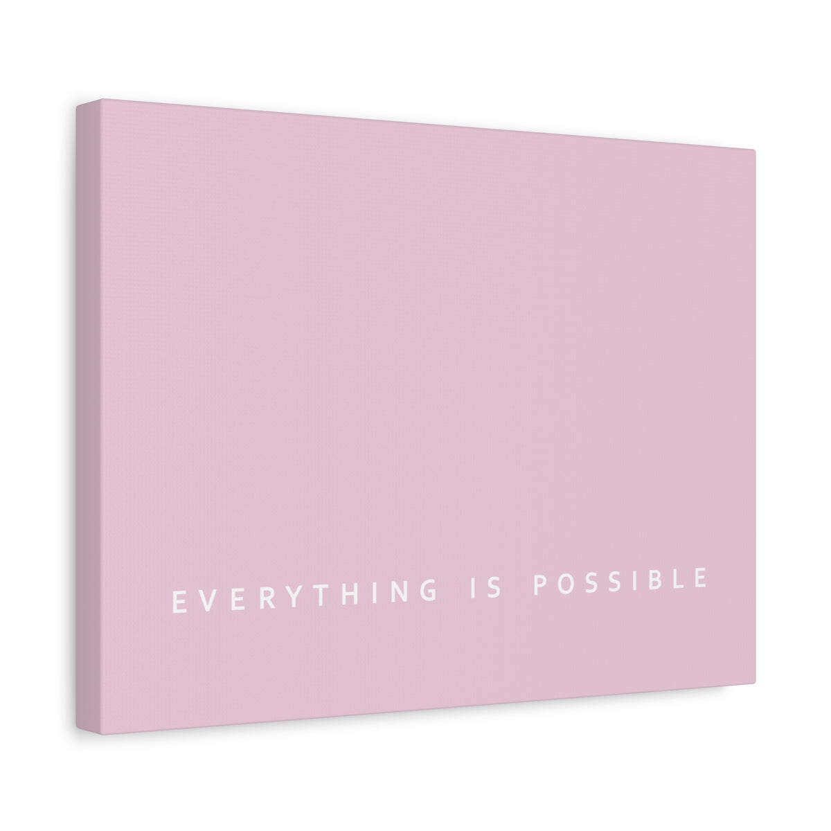 A pink canvas wall art print with the phrase 'EVERYTHING IS POSSIBLE' in white text at the bottom, shown at a slight angle on a white background.
