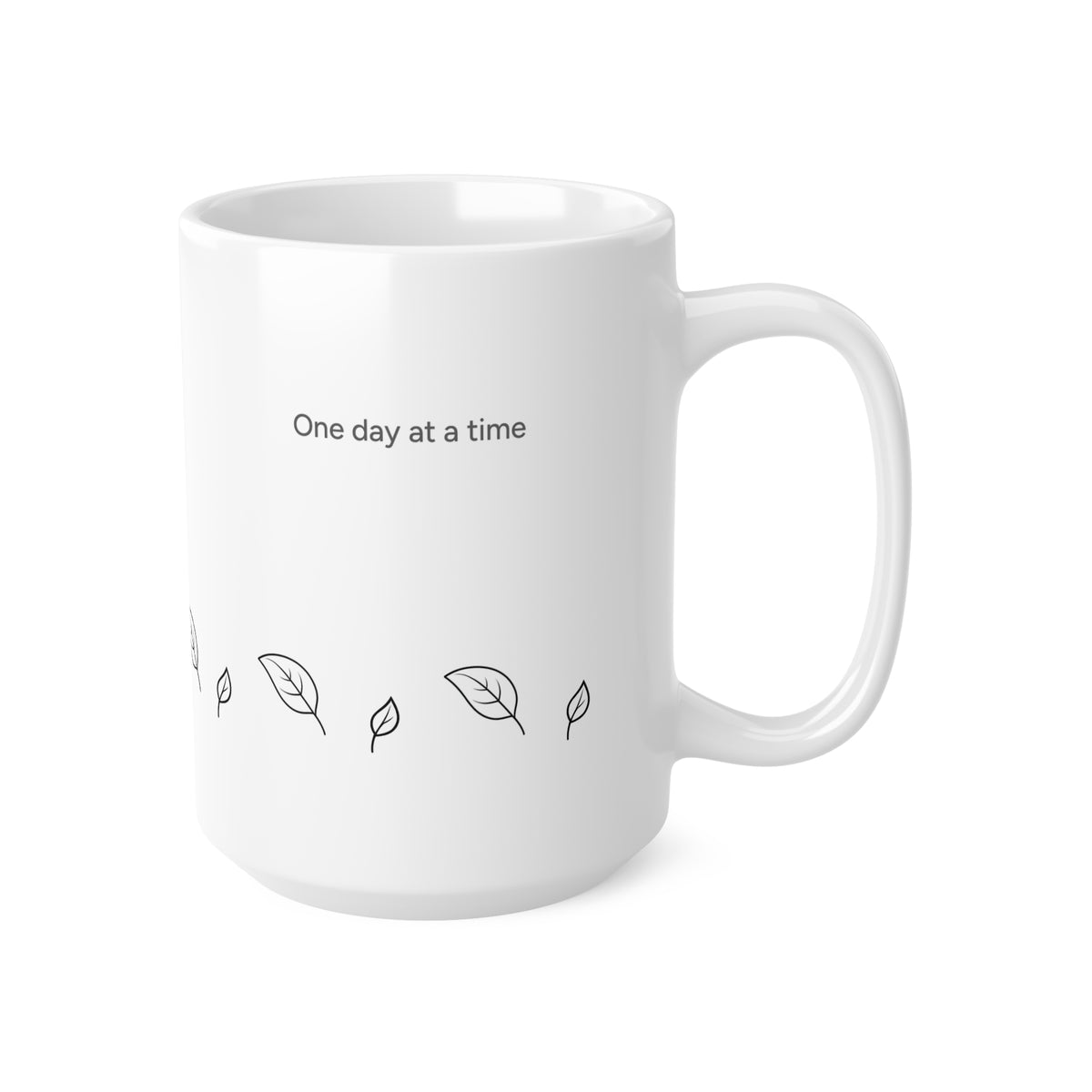 Right side view of 15oz white ceramic mug with a black printed text reading 'One day at a time' and small leaf illustrations, shown on a clean white background.