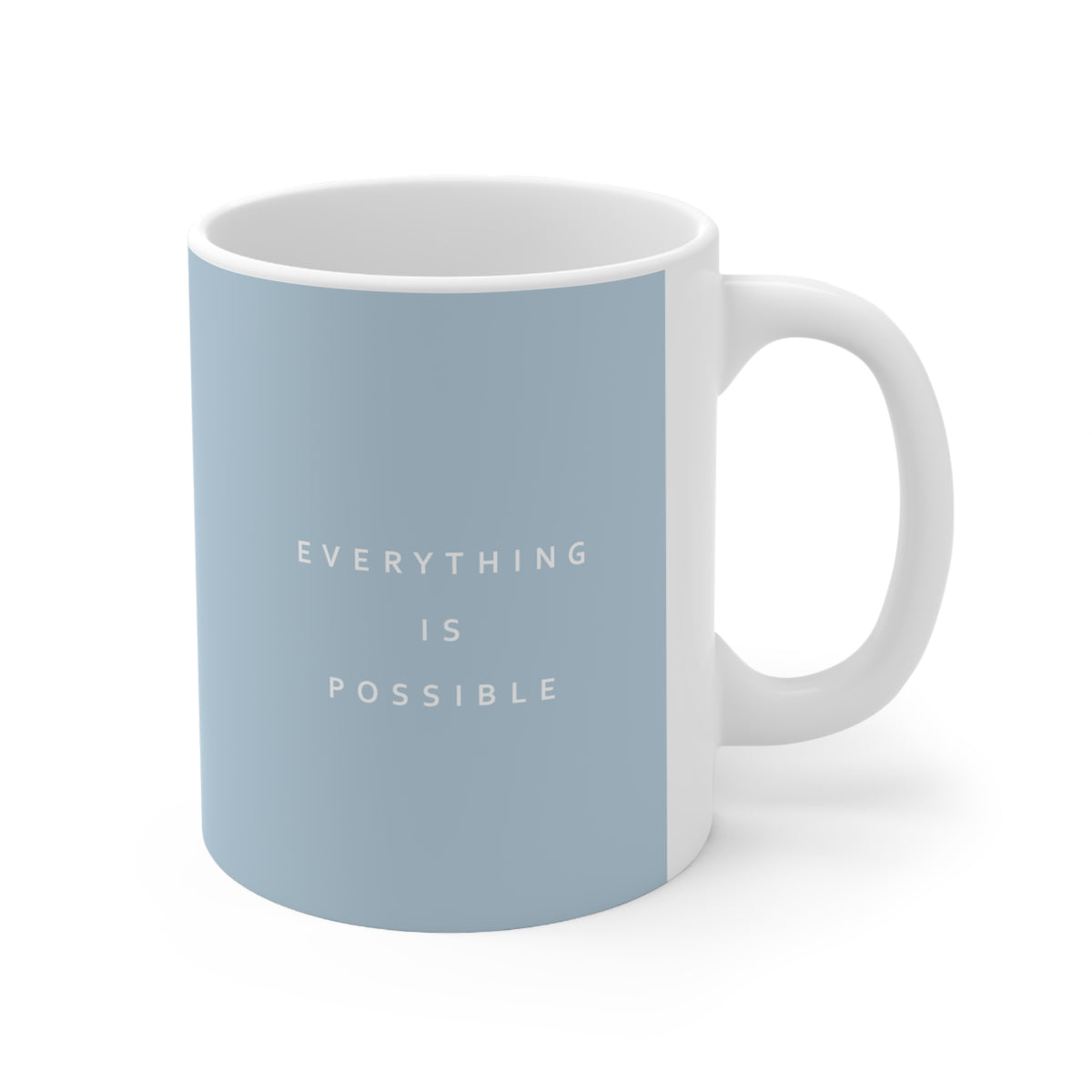Right side view of blue ceramic minimalist mug, 11oz size, showing ‘Everything is possible’ text and handle