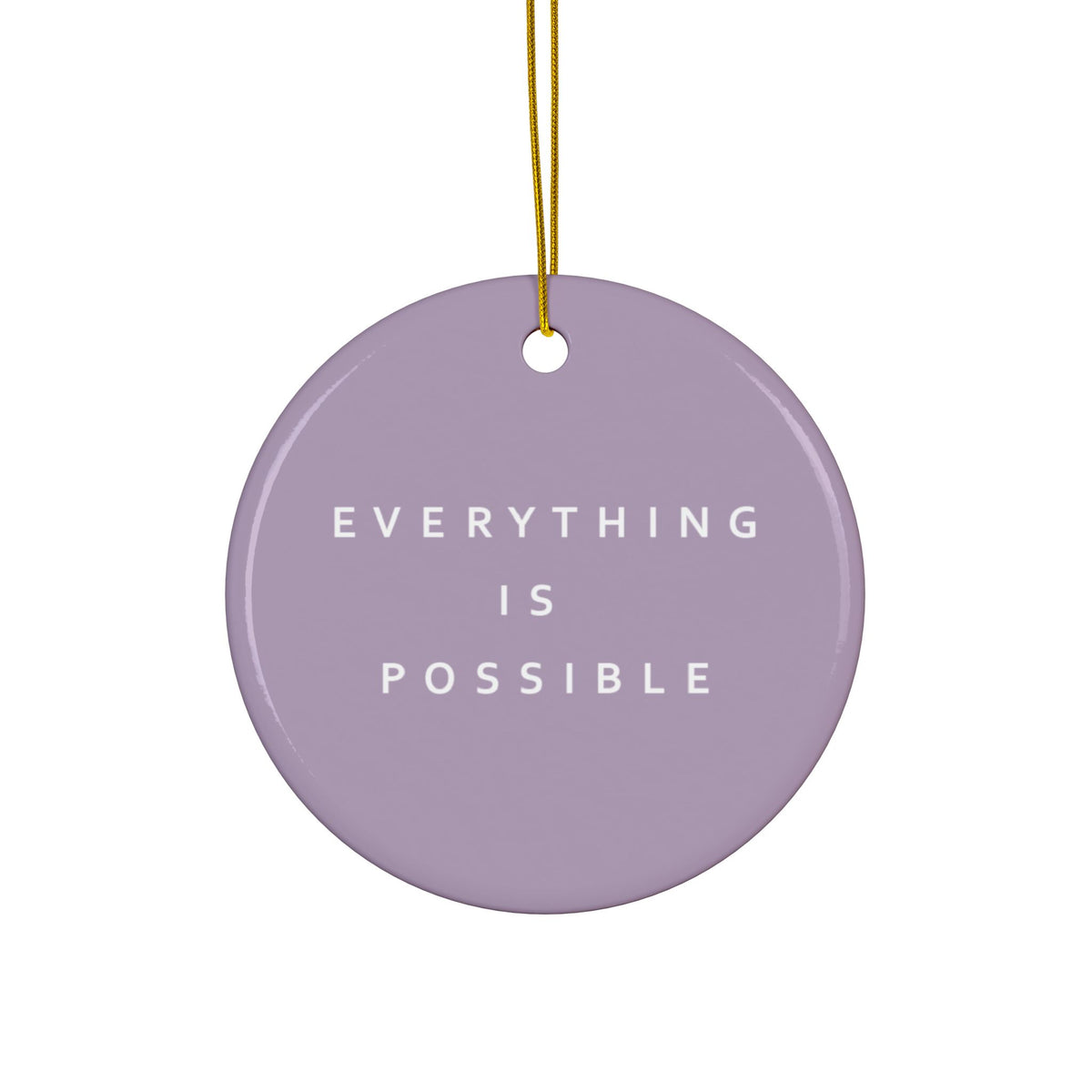 A round lavender ceramic ornament with the phrase 'EVERYTHING IS POSSIBLE' printed in white capital letters, hanging from a gold string against a plain white background.