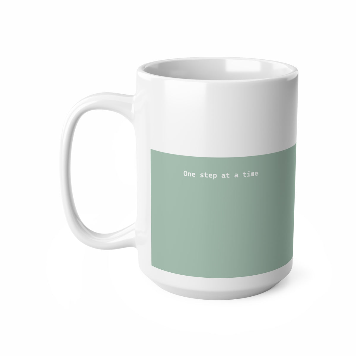 Left side view of green and white ceramic minimalist mug, 15oz size, showing ‘One step at a time’ text and handle