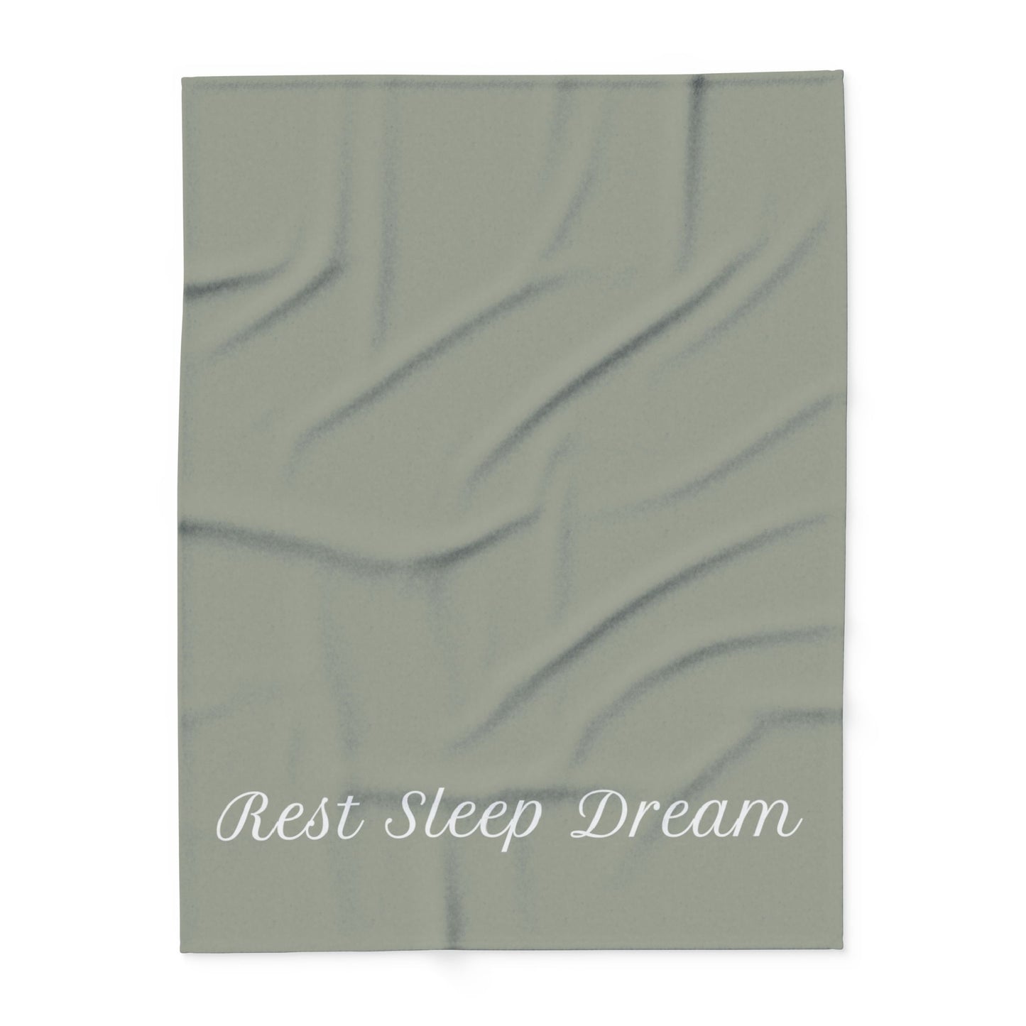 Green blanket with large, elegant font in white for the text ‘Rest Sleep Dream’ along the bottom.