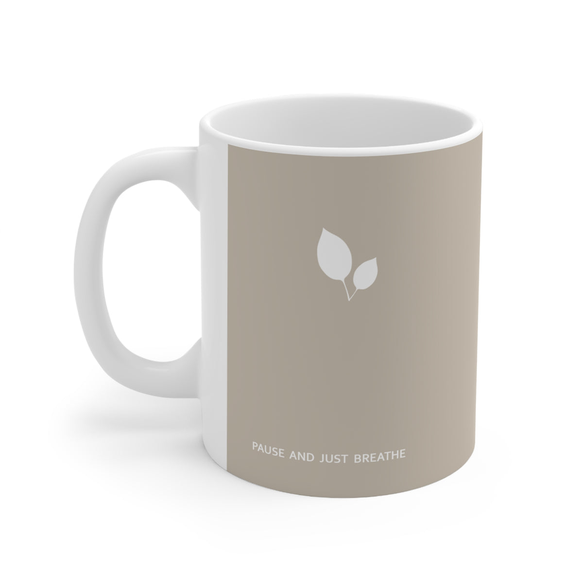 Left side view of brown ceramic leaf mug, 11oz size, showing leaf cluster, ‘Pause and just breathe’ text and handle