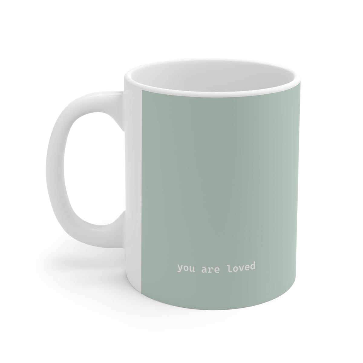 Left side view of green ceramic minimalist mug, 11oz size, showing ‘you are loved’ text and handle