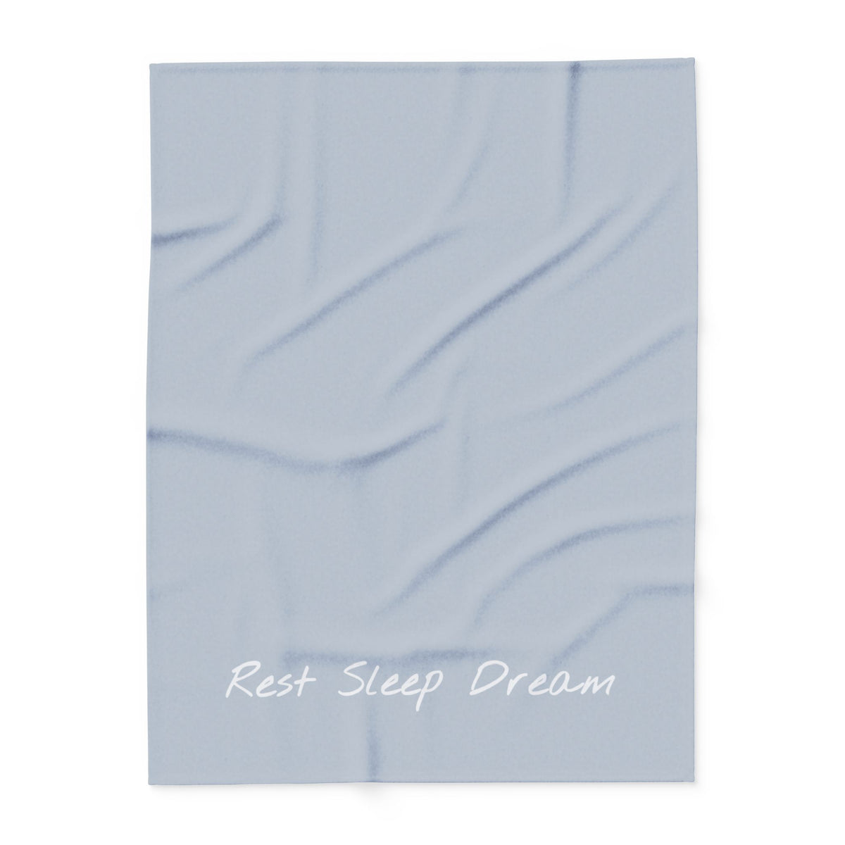 Light blue blanket with large font in white for the text ‘Rest Sleep Dream’ along the bottom.
