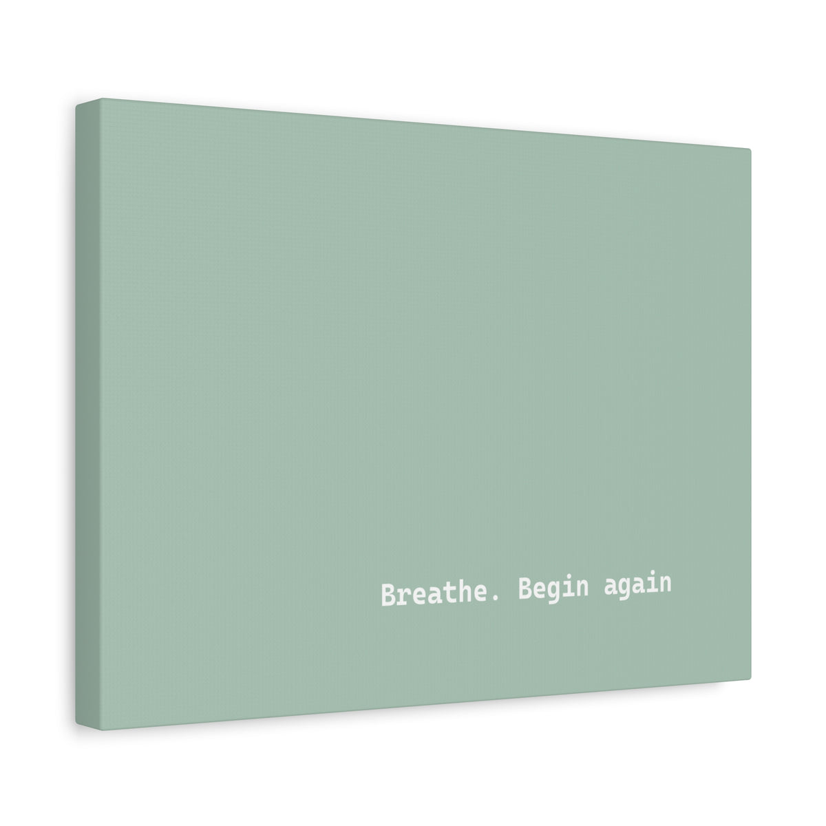 A minimalist canvas wall art print in a muted sage green color, featuring the white text 'Breathe. Begin again' near the bottom right.