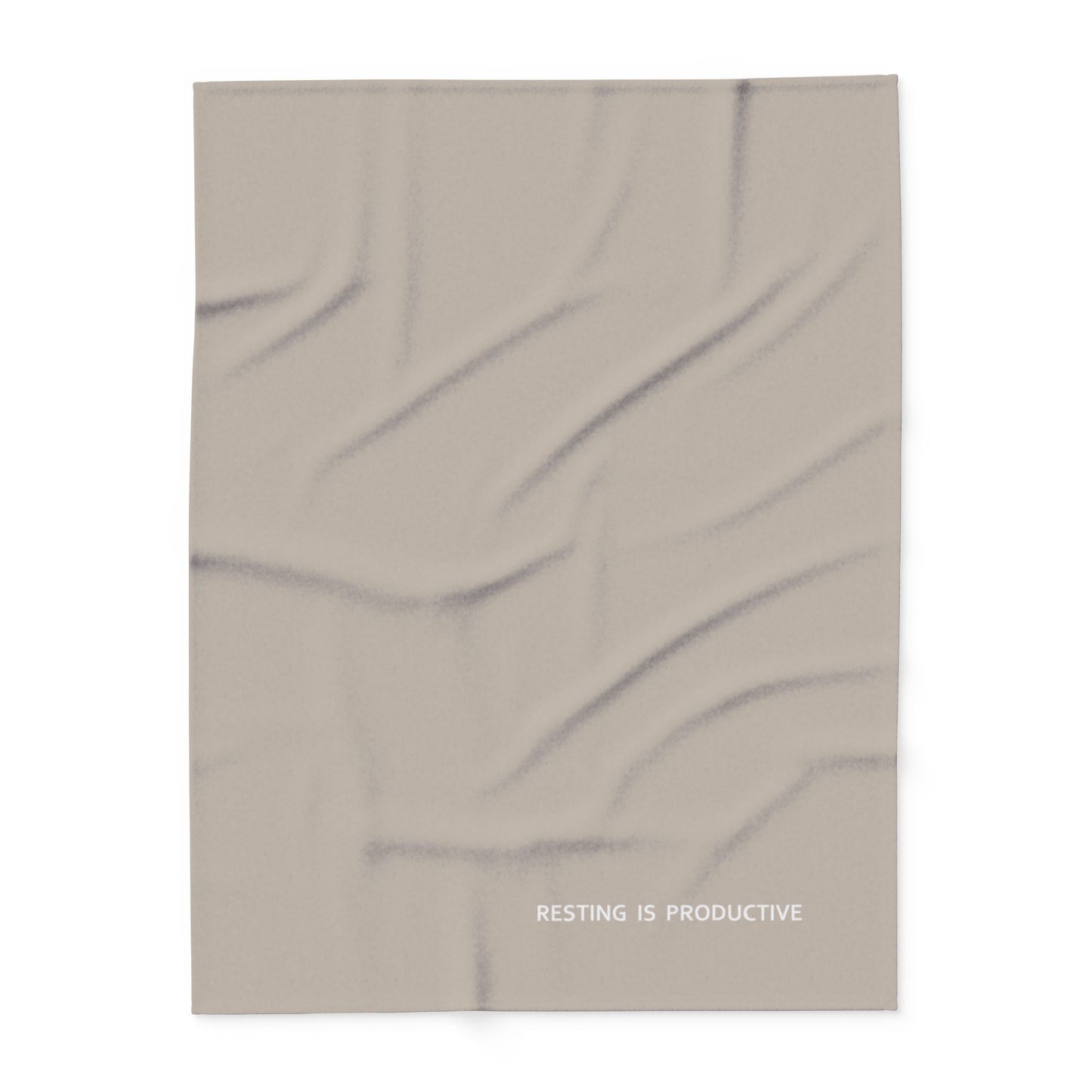 Beige blanket with tiny modern font in white for the text ‘Resting is Productive’ along the bottom.