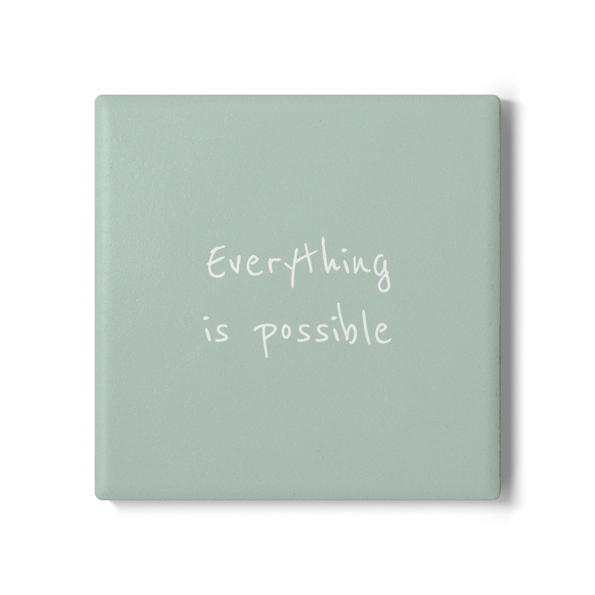A square light green coaster with the phrase 'Everything is possible' written in white script, shown on a clean white background.