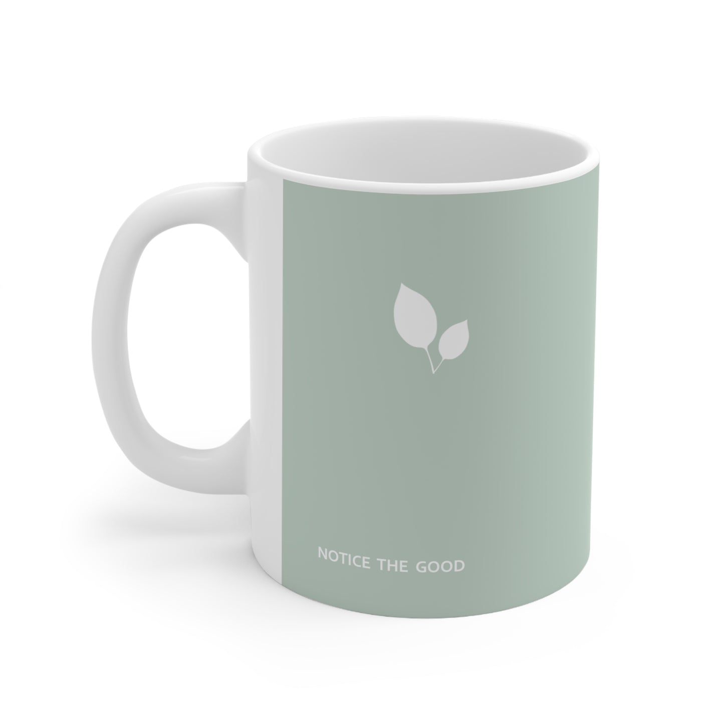 Left side view of green ceramic leaf mug, 11oz size, showing leaf cluster, ‘Notice the good’ text and handle