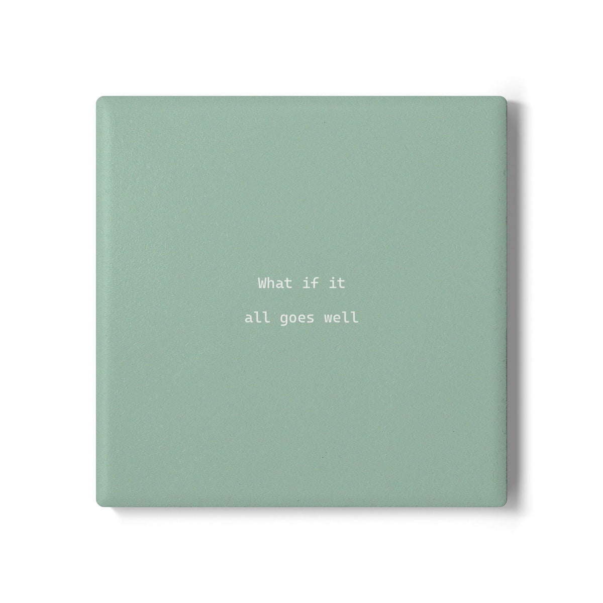 Green square ceramic coaster with modern style text ‘What if it all goes well’ in white font.