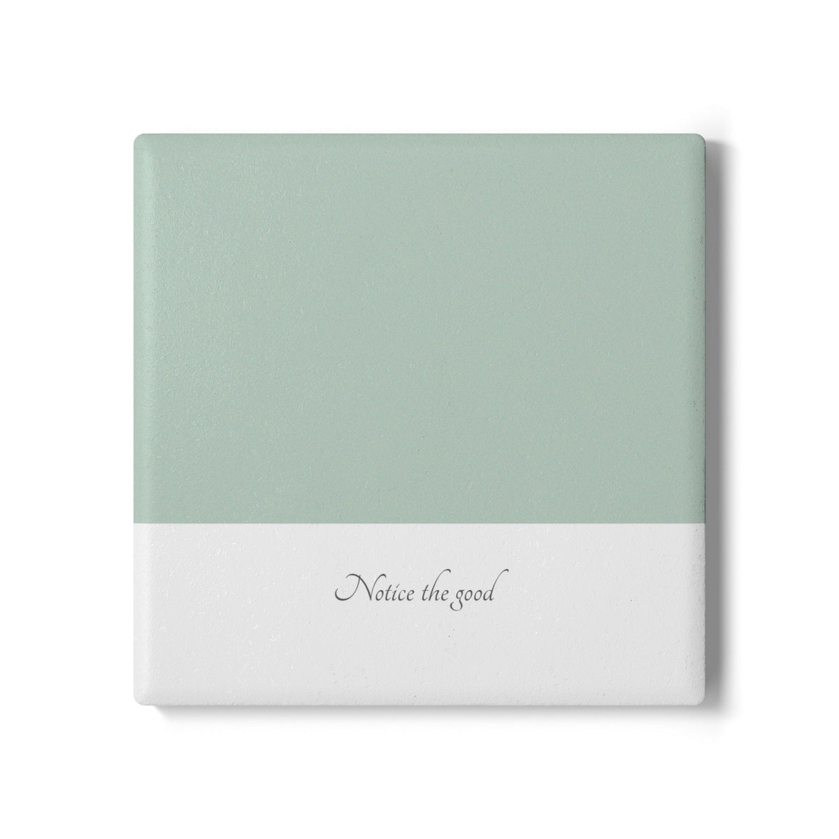 A square ceramic tile coaster with a dual-tone design, featuring a sage green top half and a white bottom half with the cursive text 'Notice the good' in gray. The tile is shown on a clean white background with a soft drop shadow.