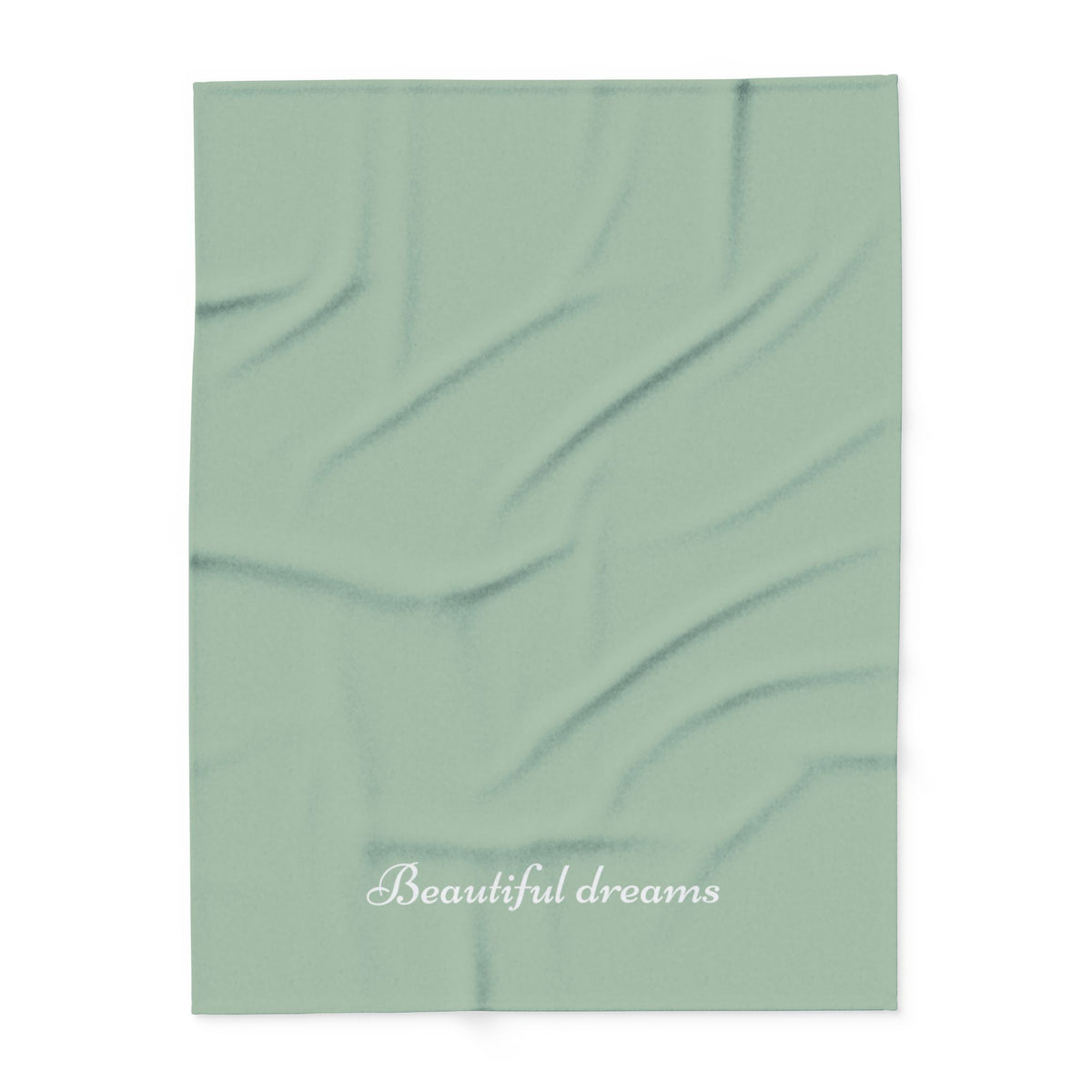 Green blanket with elegant font in white for the text ‘Beautiful dreams’ along the bottom.