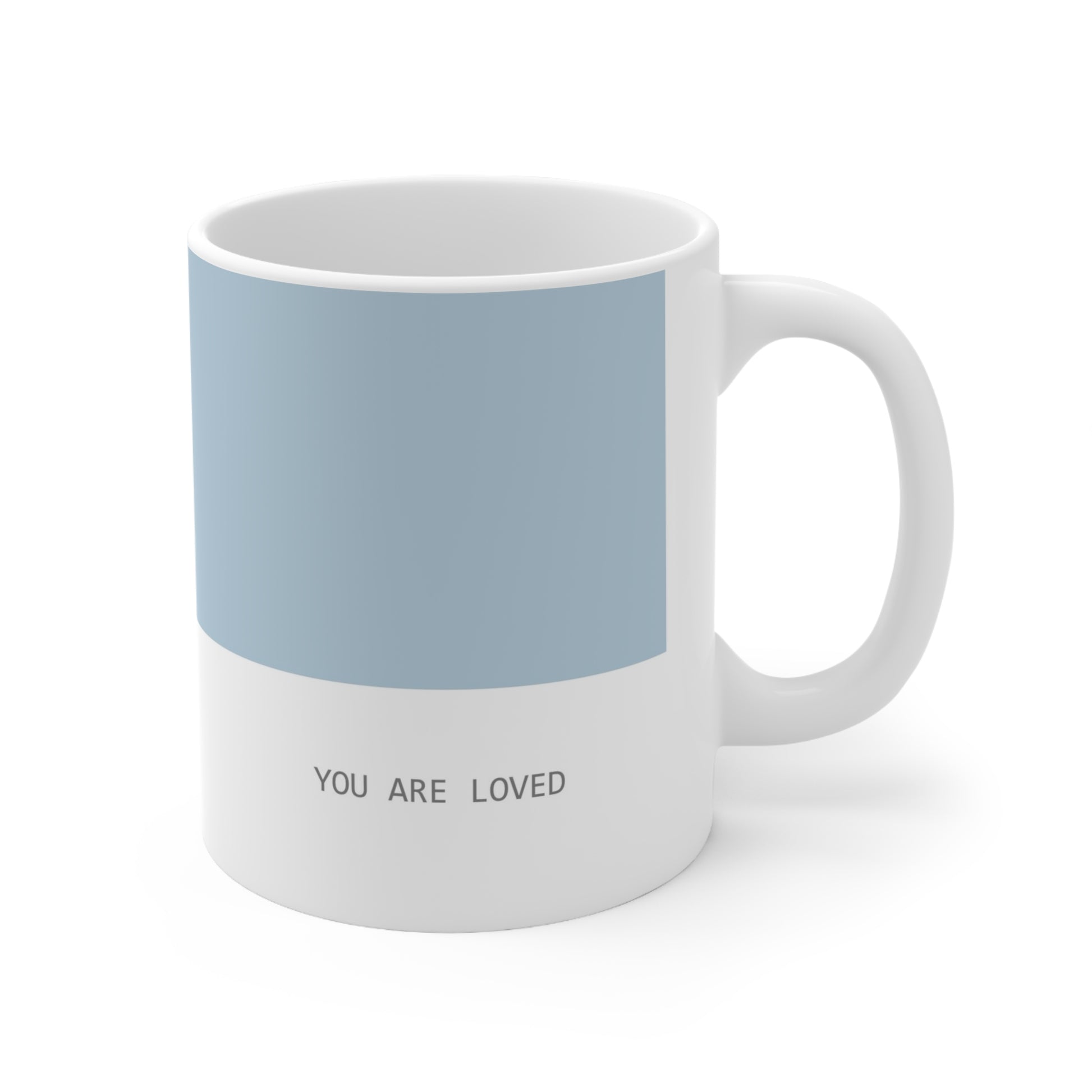 Right side view of blue and white ceramic minimalist mug, 11oz size, showing ‘you are loved’ text and handle