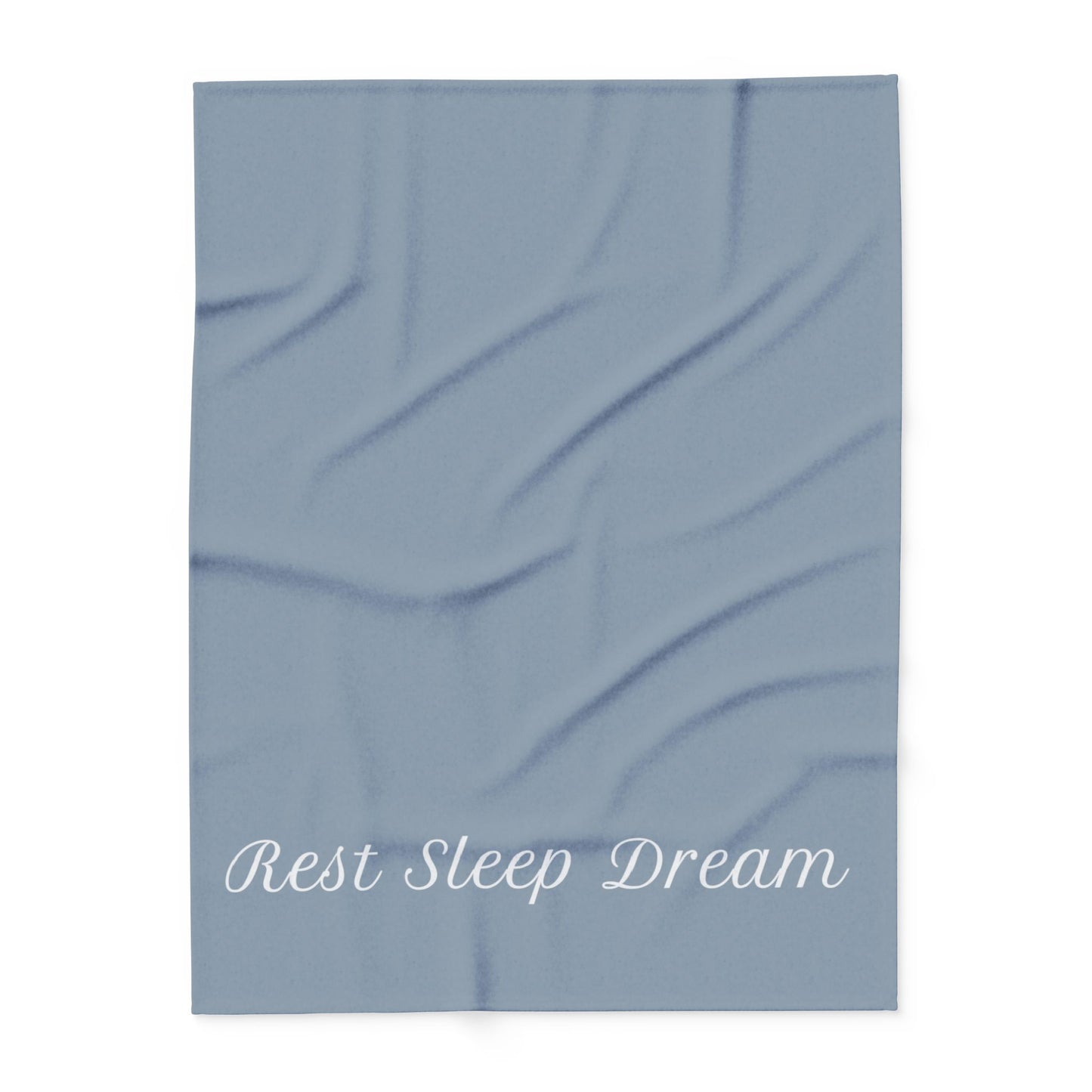 Blue blanket with large, elegant font in white for the text ‘Rest Sleep Dream’ along the bottom.