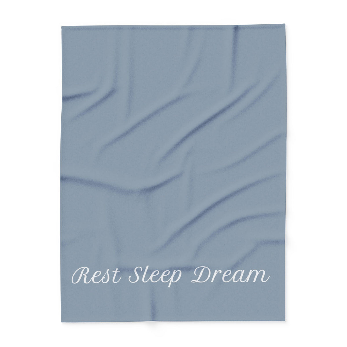 Blue blanket with large, elegant font in white for the text ‘Rest Sleep Dream’ along the bottom.