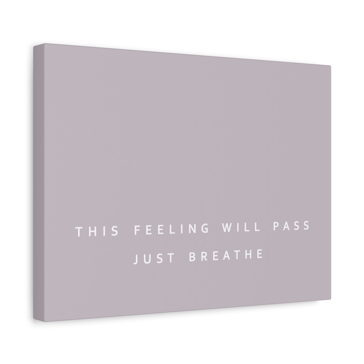 A rectangular canvas wall art print in a pale taupe brown color, featuring the text 'THIS FEELING WILL PASS JUST BREATHE' in white sans-serif lettering. The canvas is shown at a slight angle against a clean white background.