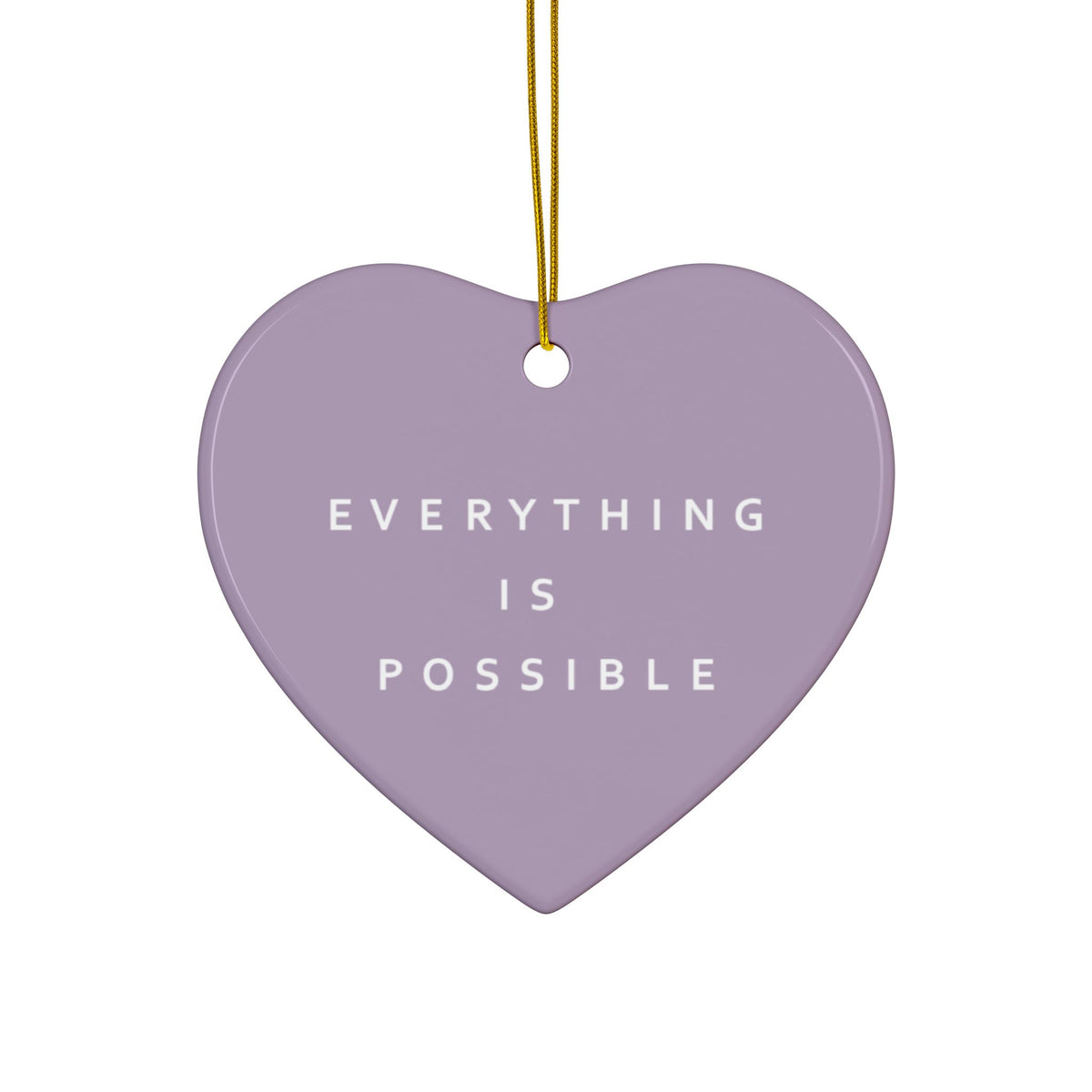 A heart-shaped lavender ceramic ornament with the phrase 'EVERYTHING IS POSSIBLE' printed in white text, hanging from a gold string against a plain white background.
