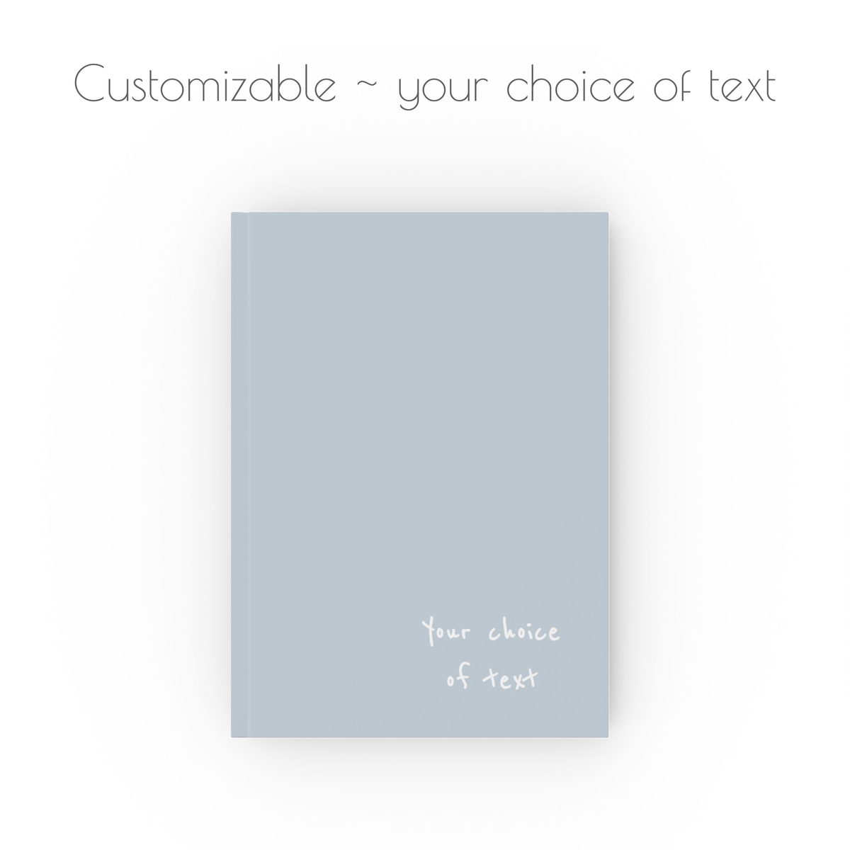 A light blue, hardcover, a5 journal notebook with white handwritten style text that is customizable with your choice of personalized text.