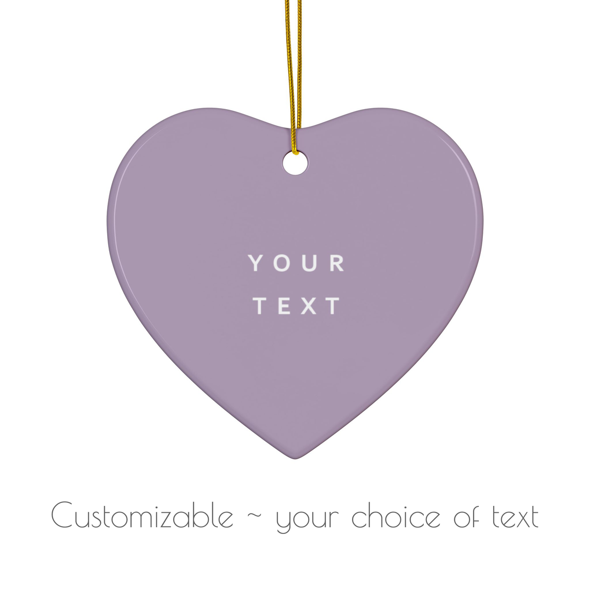 A heart-shaped hanging ornament in a soft lavender-purple color with a gold hanging string and white placeholder text reading 'YOUR TEXT'. Below, smaller gray text says 'Customizable ~ your choice of text'.