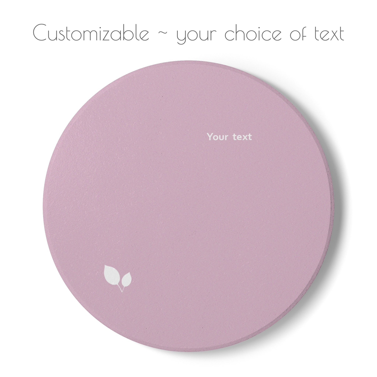 Pink round ceramic coaster with delicate leaf motif design, and your choice of personalized text. 