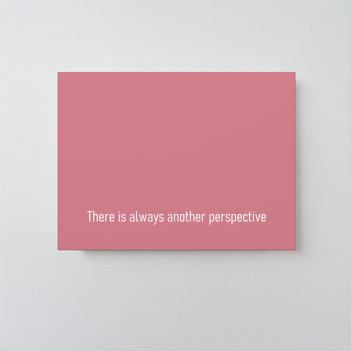 A red art canvas print with the white text 'There is always another perspective' near the bottom, displayed against a light gray textured wall.