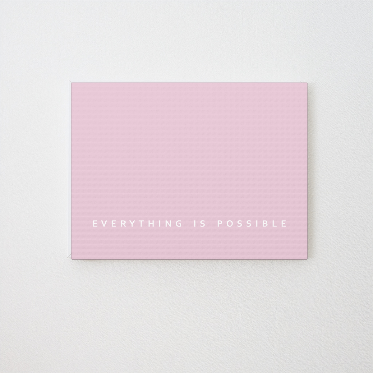 A minimalist pink art print canvas with the phrase 'EVERYTHING IS POSSIBLE' printed in small white uppercase letters near the bottom, displayed against a clean white background.