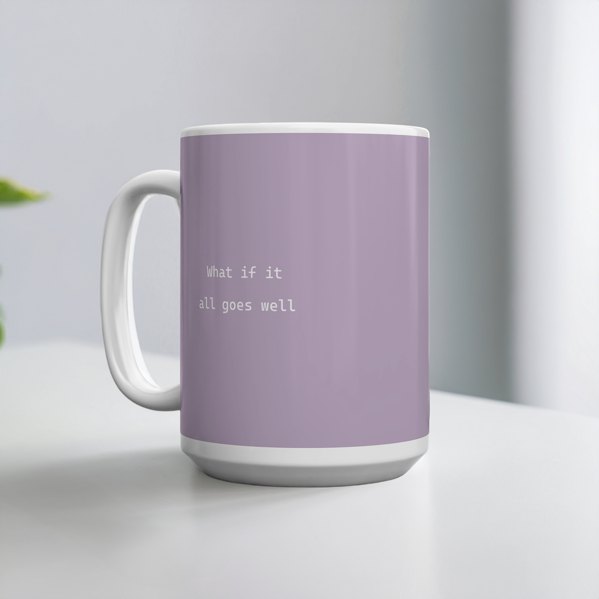 Purple ceramic mug with small white font in the middle ‘What if it all goes well’. The mug sits on a white table, minimalist background.