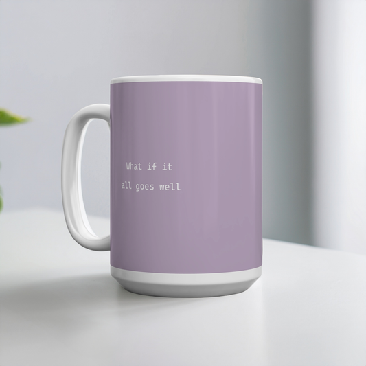 Purple ceramic mug with small white font in the middle ‘What if it all goes well’. The mug sits on a white table, minimalist background.