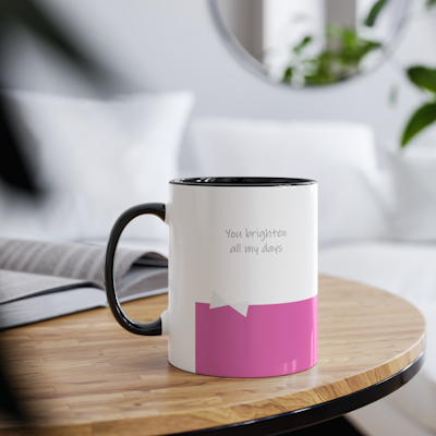 pink and white ceramic mug with bow. black handle. black inside. the words, You brighten all my days.