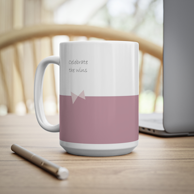 dark pink and white ceramic mug with bow, and the words, celebrate the wins