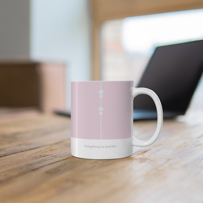 pink and white ceramic mug with delicate circle design, and the words, Everything is possible